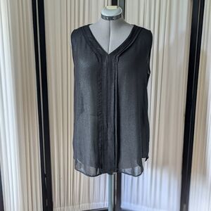 Black,sleeveless,shiny/sheer with ruffles at the front,stretchy at the back, top